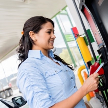 A women paying at a gas pump