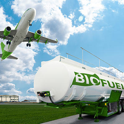 An airplane takes off from the airport and flies over a tanker of biofuel.